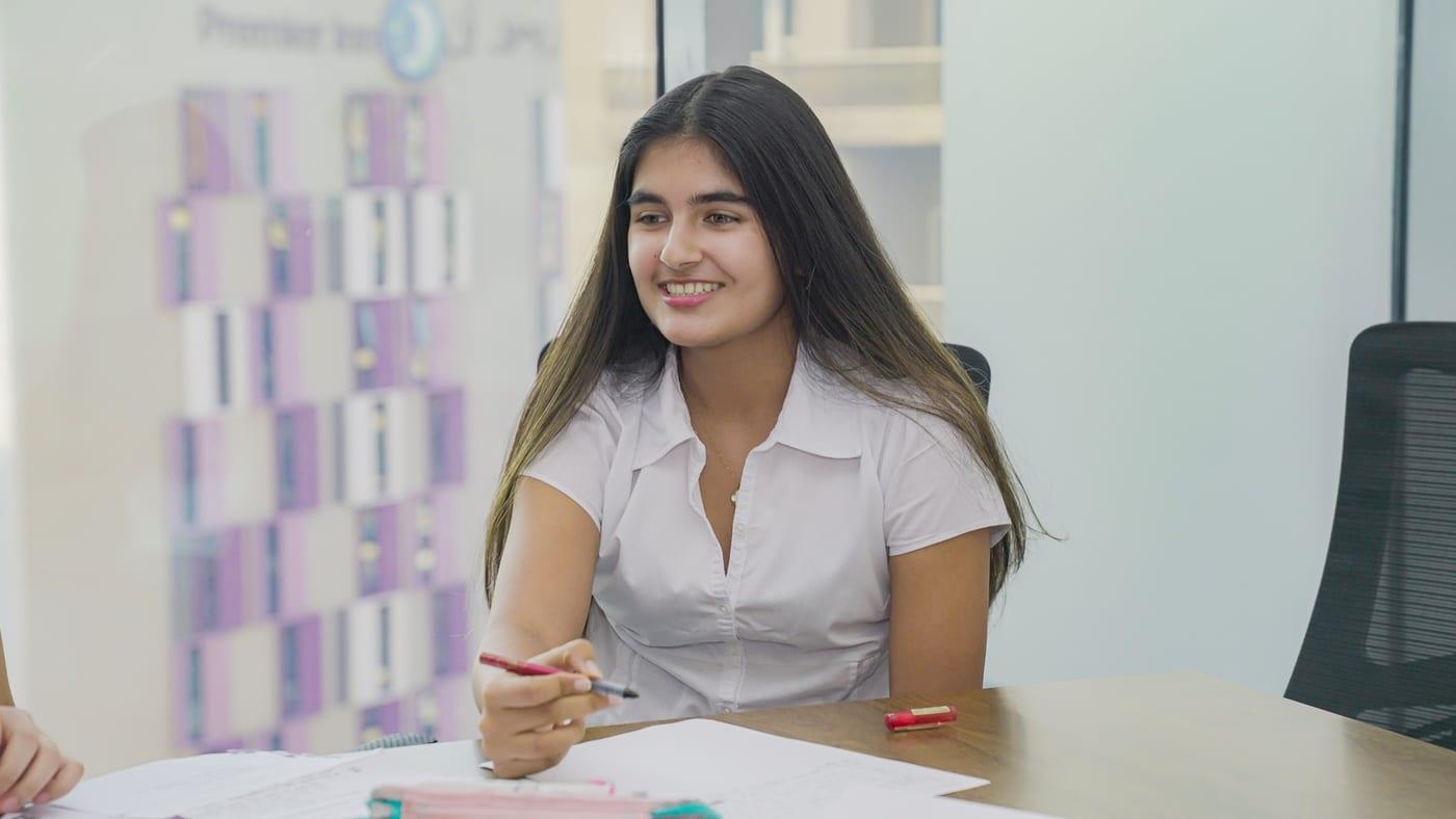 A student makes her point during a drafting session at the table